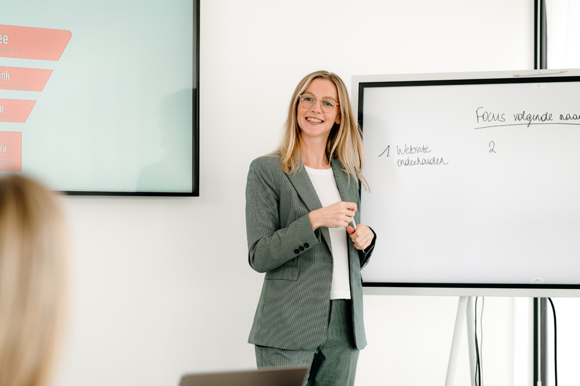 Celine Barremaecker leading a marketing working session at a whiteboard